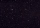 Deep 'jet black' background, with charcoal flecks, and occasional pintpoints of a reflective gold tone