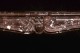 The center of the mantel is detailed