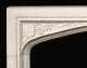 Floral details and a Coat of Arms add to this Hampton Court marble surround.