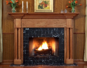 The Princeton custom fireplace mantel has smooth column legs that sit on a square base