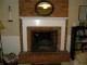 Flush mount Monticello mantel installed on brick wall and hearth.