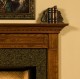 Dentil molding under the top shelf of the mantel.