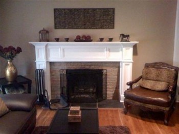 An upgraded room with the Oxford fireplace mantel shown in a white paint grade.