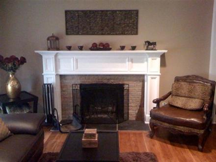 An upgraded room with the Oxford fireplace mantel shown in a white paint grade.