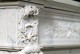 Wreath design above mantel leg.