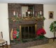 Boxwood mantel shelf decorated for the holidays.